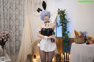 A woman in a bunny costume sitting on a table.