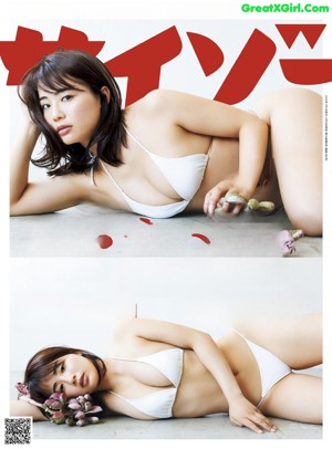 A woman laying on top of a bed next to a pillow.