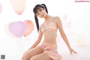 A young woman in a bikini posing for a picture.