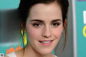 A woman in a white shirt and yellow pants posing for a picture.