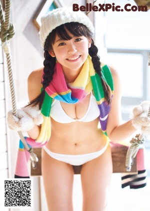 A woman in a red bikini posing for a magazine.