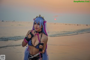 A woman in a bikini with purple hair and a crown on her head.