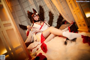 A woman in a bunny costume sitting on a chair.