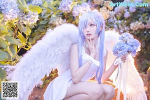 A woman with long blue hair wearing a bunny costume.