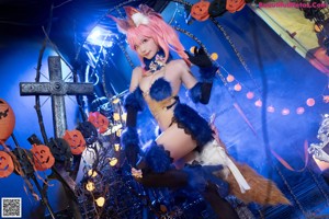 A woman with pink hair wearing a bunny costume.
