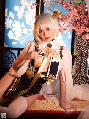 A woman in a white and black outfit posing for a picture.