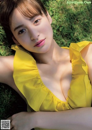 A woman in a white towel is posing for a picture.