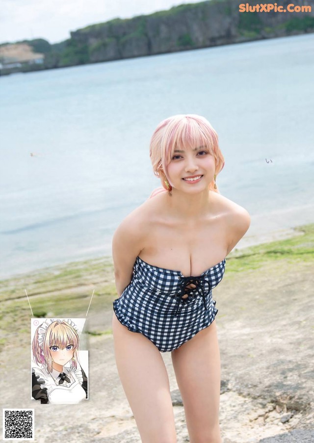 A woman in a bathing suit standing on a beach.