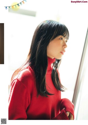 A young woman wearing headphones and a backpack.