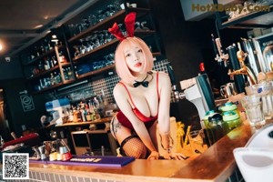 A woman sitting on top of a wooden table.