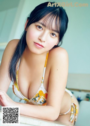 A woman in a pink bikini posing for a picture.