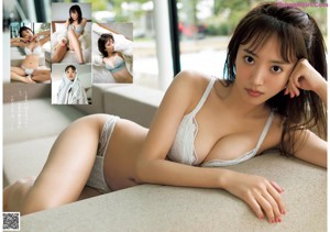 A woman in a white bra and panties laying on a couch.