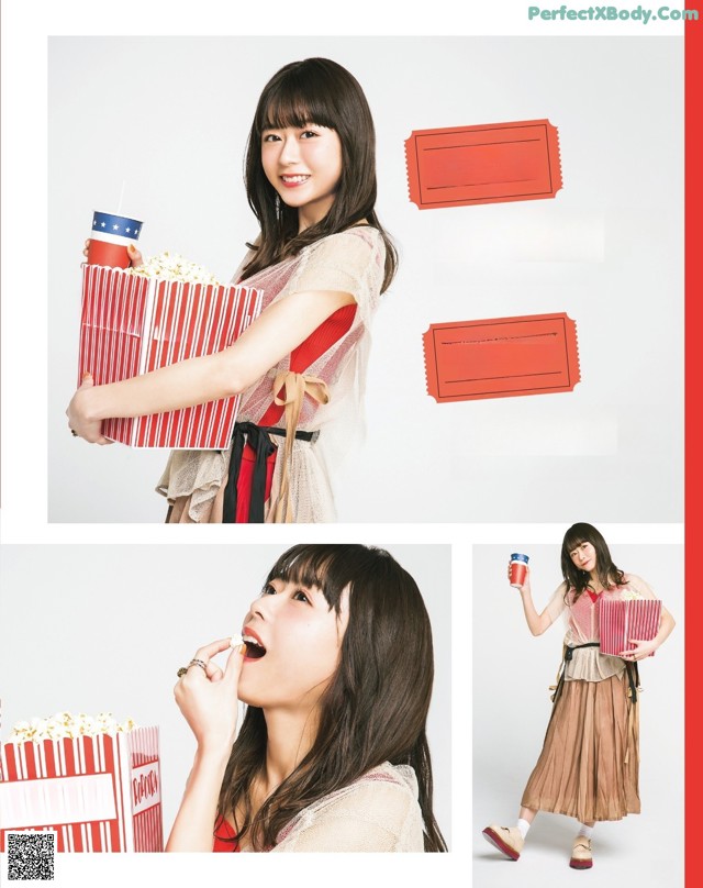A woman holding a box of popcorn and a cup of coffee.